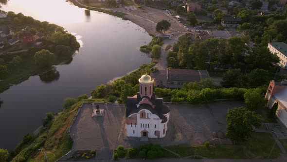 Small Church at the Bank of the River at the Summer Sunset Filmed By Drone in Small European City