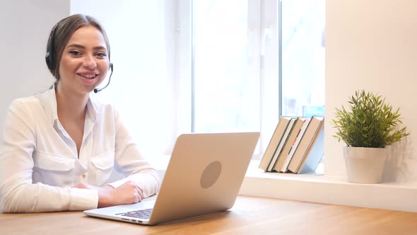 Call Center Girl Smiling Toward Camera at Work