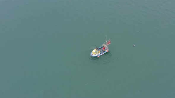 Fishing Vessel Pulling Nets and Catching Fish Aerial View