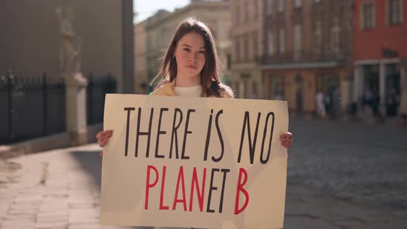 Woman Holding Banner with Phrase There is No Planet B