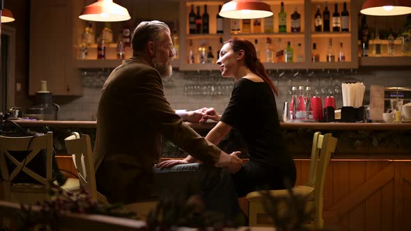 conversation of two close friends, a man and a woman in a bar