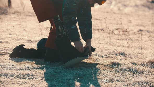 Man with Prosthetic Leg Setting Boots on Snowboard