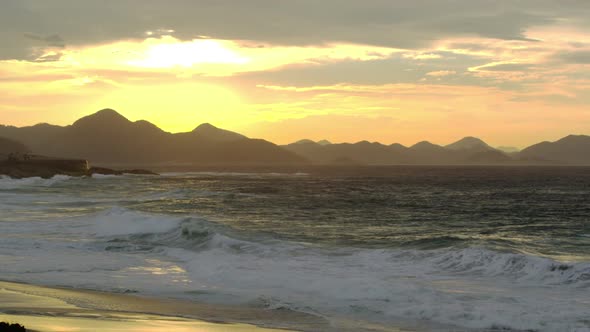 Waves breaking on Ipanema beach at sunset