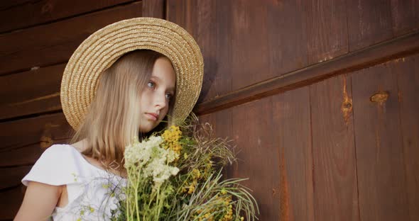 Portrait Young Romantic Woman in Rustic Hat From Straw with Wildflowers Bouquet on Wooden Background