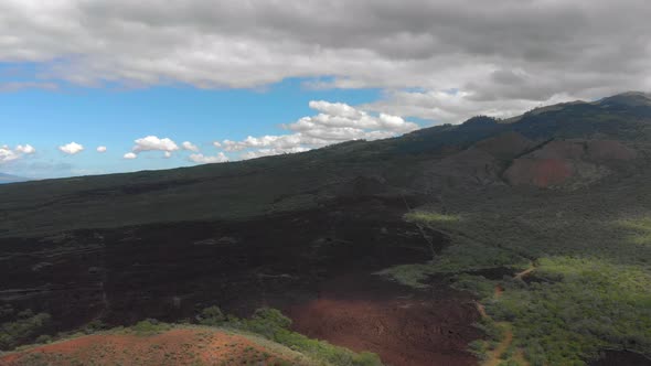 4k drone Maui upcountry on highway 31 looking towards Haleakala Mountain. February sky.