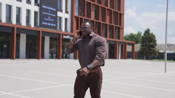 African businessman talking on mobile phone on street