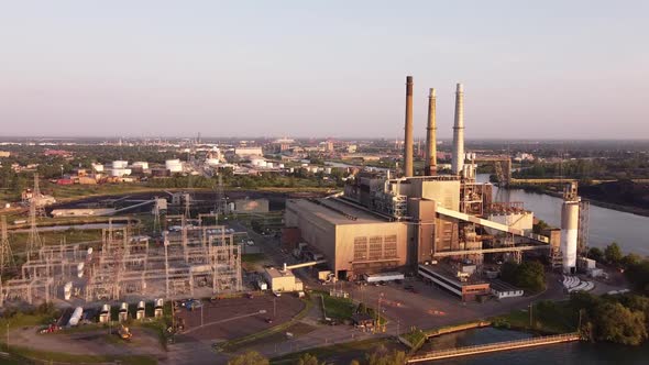 Drone Flying Towards DTE Rouge River Coal Powerplant In Michigan On A Sunny Morning - aerial