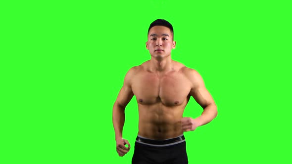 Athlete Man Runs on the Green Screen Background. Front View