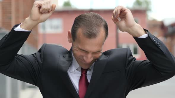 Happy Businessman Listening Music and Dancing