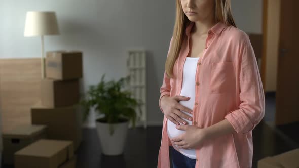 Sorrowful Pregnant Woman Looking at Boxes With Things, Husband Leaving Family