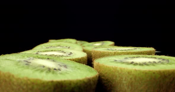 Green fresh kiwi fruit cut in half super macro