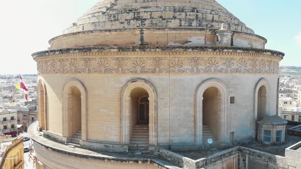 Closeup aerial 4k drone footage of the Mosta Rotunda Dome revealing the surroundings of the city