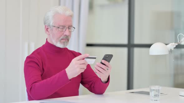 Old Man Excited By Online Shopping Success on Smartphone