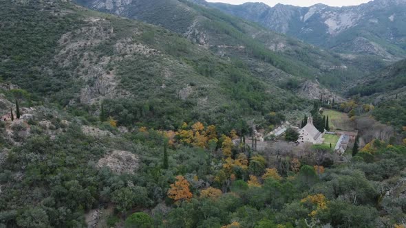 Panning: Picturesque old monastery nestled into narrow Spanish valley