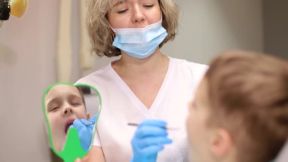 Happy with the work of a child dentist, close-up of a happy little boy in the hospital