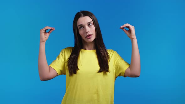 Pretty Hispanic Woman Showing Blablabla Gesture with Hands and Rolling Eyes Isolated on Blue