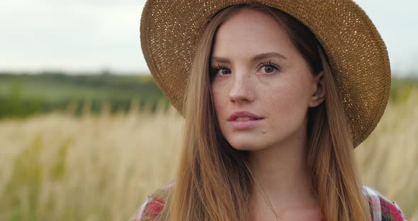 Portrait of Cute Ginger Woman Smilingly turned to the Camera on the Outdoors.