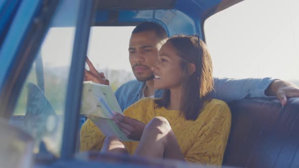 Young couple on a road trip in their pick-up truck