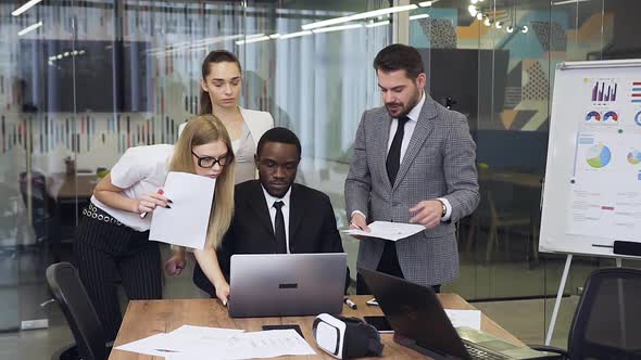 Mixed Race Business People which Discussing Joint Project in Meeting Room