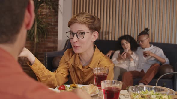 Short-haired Woman Talking with Friends in Cafe