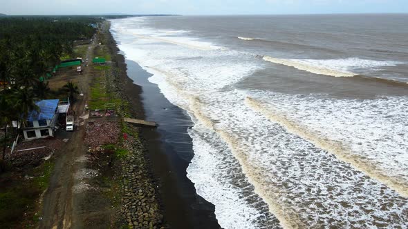 beach at vasi rajodi beach  waves india mumbai maharashtra drone shot india birds eye view brown sea