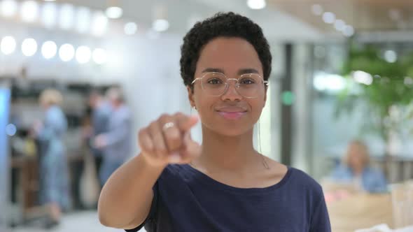 Portrait of Casual African Woman Pointing at the Camera 