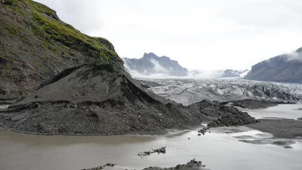 Tourists Standing In The Pile Of Sand Near The Skaftafellsjokull Glacier In Iceland. - aerial