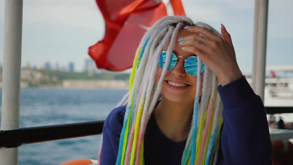 Attractive Young Girl Against Background of Turkish Flag Sailing on a Ship