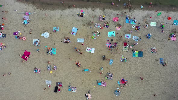 Top View of the Beach Featuring Colorful Umbrellas and People Relaxing