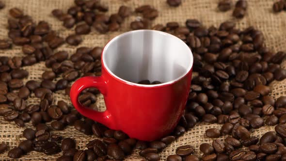 Coffee Beans Falling Into Red Cup