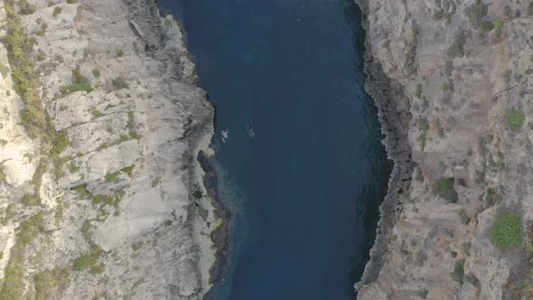 People swimming in the Wied il-Għasri sea canyon,Malta,overhead shot.