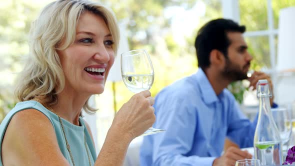 Beautiful woman having glass of wine in restaurant
