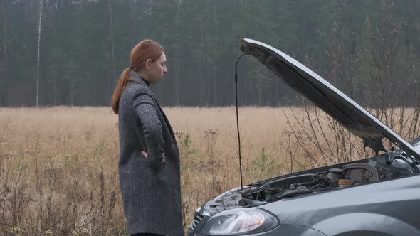 Business Woman Looking at Car Engine.