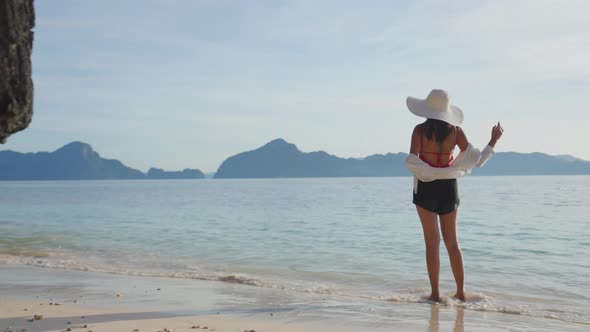 Woman Standing On Shore Of Entalula Beach