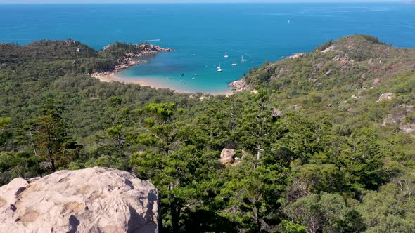 Magnetic Island landscape lookout aerial revealing Arthur Bay above boulders and trees, Queensland