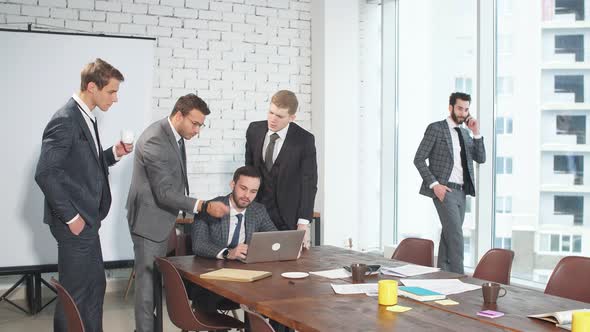 Young Men in Suits Gathered in Business Meeting