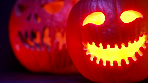 Orange Mad Pumpkin As Head of Jackolantern with Carved Eyes and Smiling Grin with Burning Fire