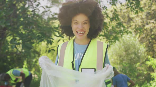 Happy family cleaning a garden together