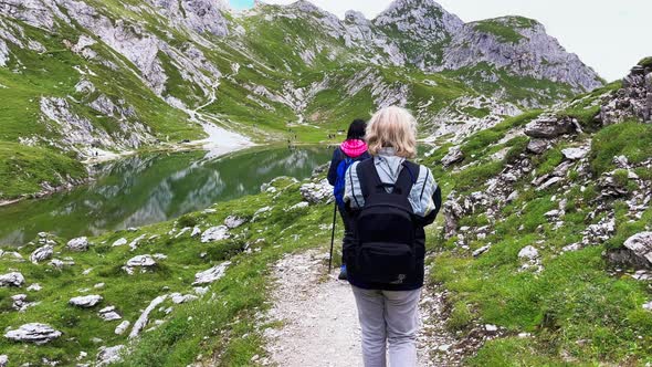 Back View of Family During a Mountain Trip Along Italian Alps