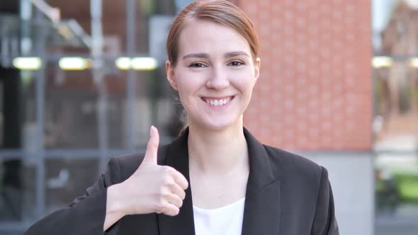 Thumbs Up By Young Businesswoman Outdoor