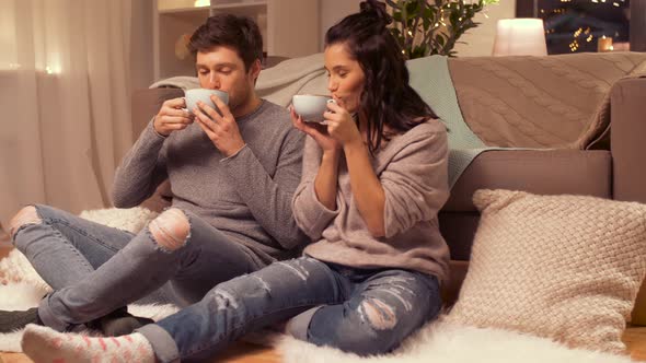 Happy Couple Drinking Hot Chocolate at Home