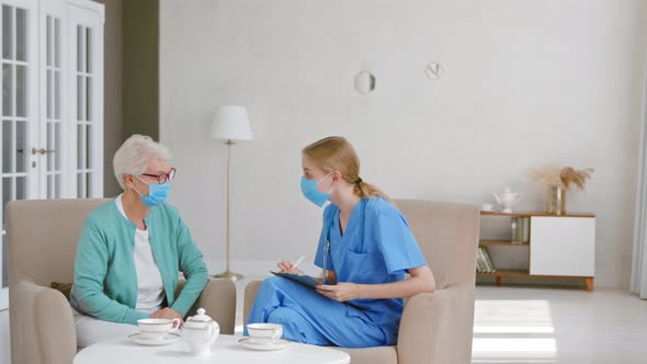 Mature grey haired female patient with medical mask at appointment