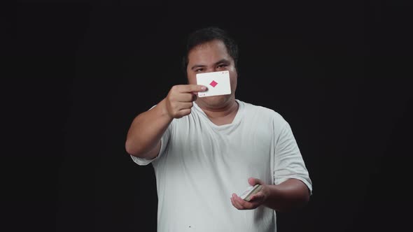 Asian Magician Performs Card Snap Change Trick. Sleight Of Hand