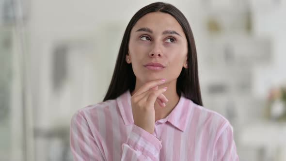 Portrait of Young Latin Woman Thinking and Getting Idea