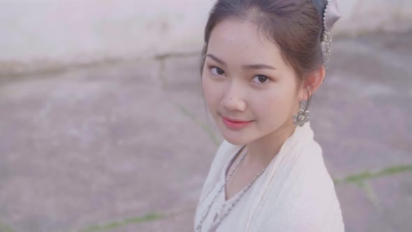 Cute Girl In Lao Traditional Costume Smiling And Looking At Camera