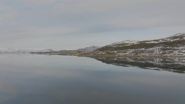 Norway Coastline Hill Slopes Reflecting In Smooth Fjord Water, Aerial