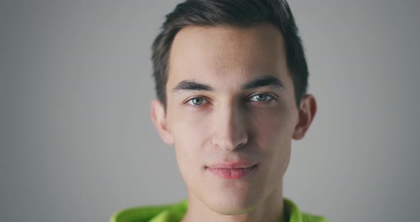 Closeup Portrait of Handsome Caucasian Man Smiling on Grey Background