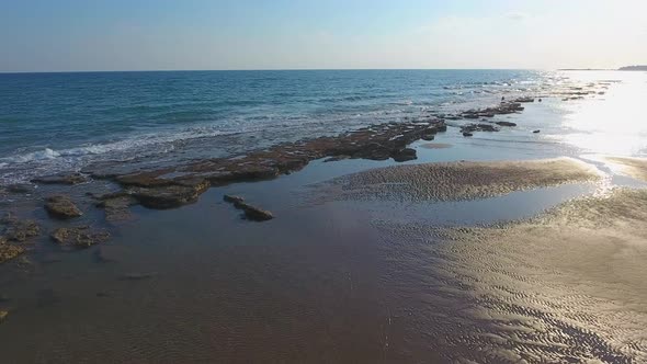 Shallow Rocky Reef Between the Sea and the Beach