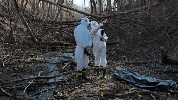 Forensic specialists working in the forest. Crime scene and police concept.