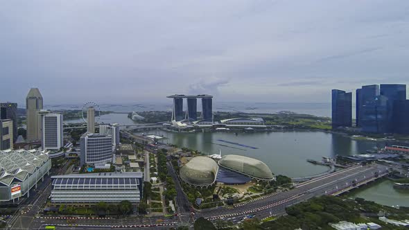 Aerial time lapse of the Marina Bay area during sunset with clouds in motion